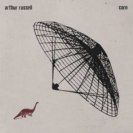 Album cover with a black wireframe design and small dinosaur illustration on a beige background, featuring the text 'Arthur Russell Corn'.