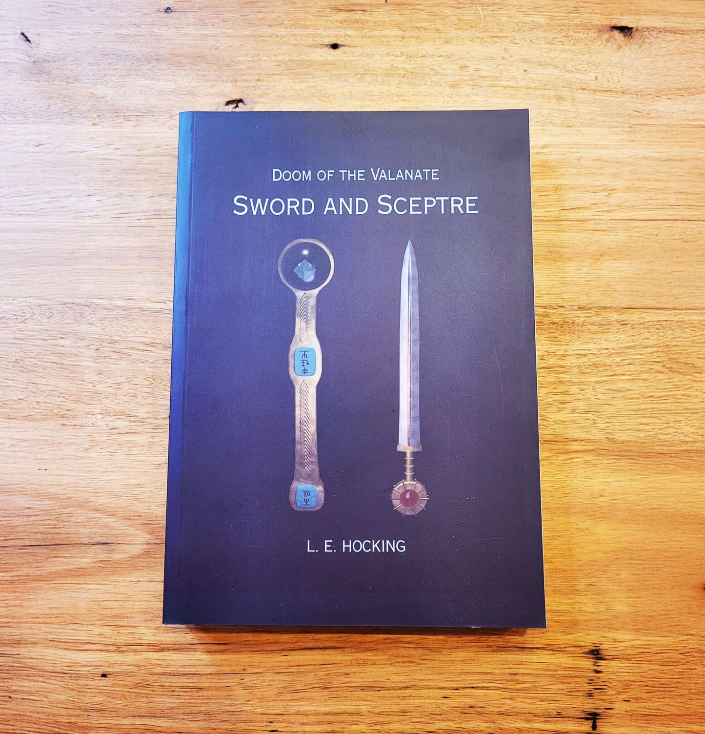 The front cover of the book 'Doom of the Valanate: Sword and Sceptre' by L.E. Hocking. 