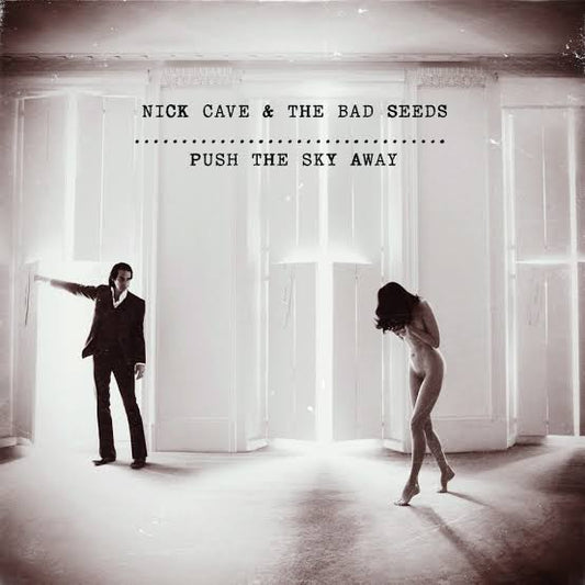Album cover for 'Push the Sky Away' by Nick Cave & The Bad Seeds featuring a man and woman in a room with light streaming through.