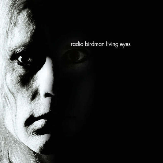 Black and white album cover art featuring a close-up of a face split by dramatic lighting, with the text 'radio birdman living eyes' on the right side.