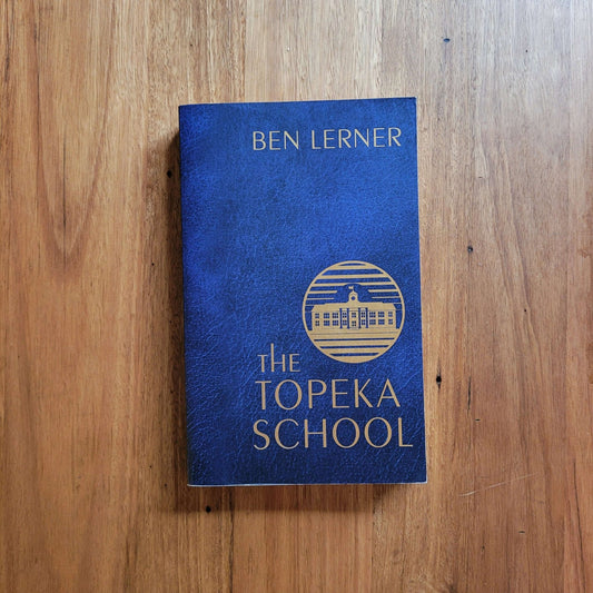 Ben Lerner - The Topeka School (Paperback) cover image on wooden surface.
