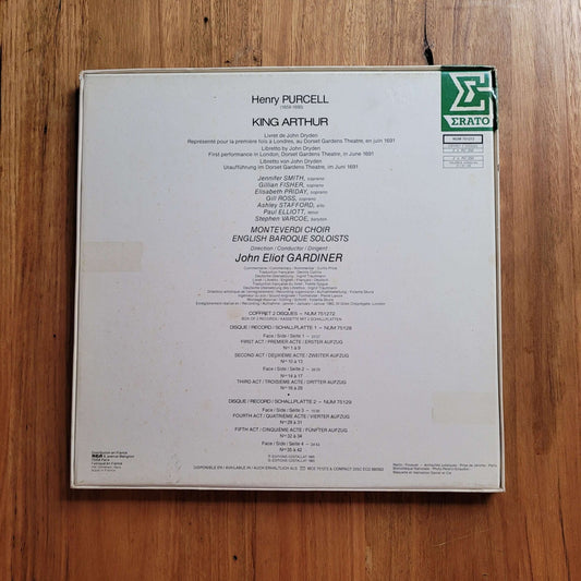 The back cover of a Erato Records vinyl record for Henry Purcell's King Arthur, featuring track listings and the Erato logo, placed on a wooden surface.