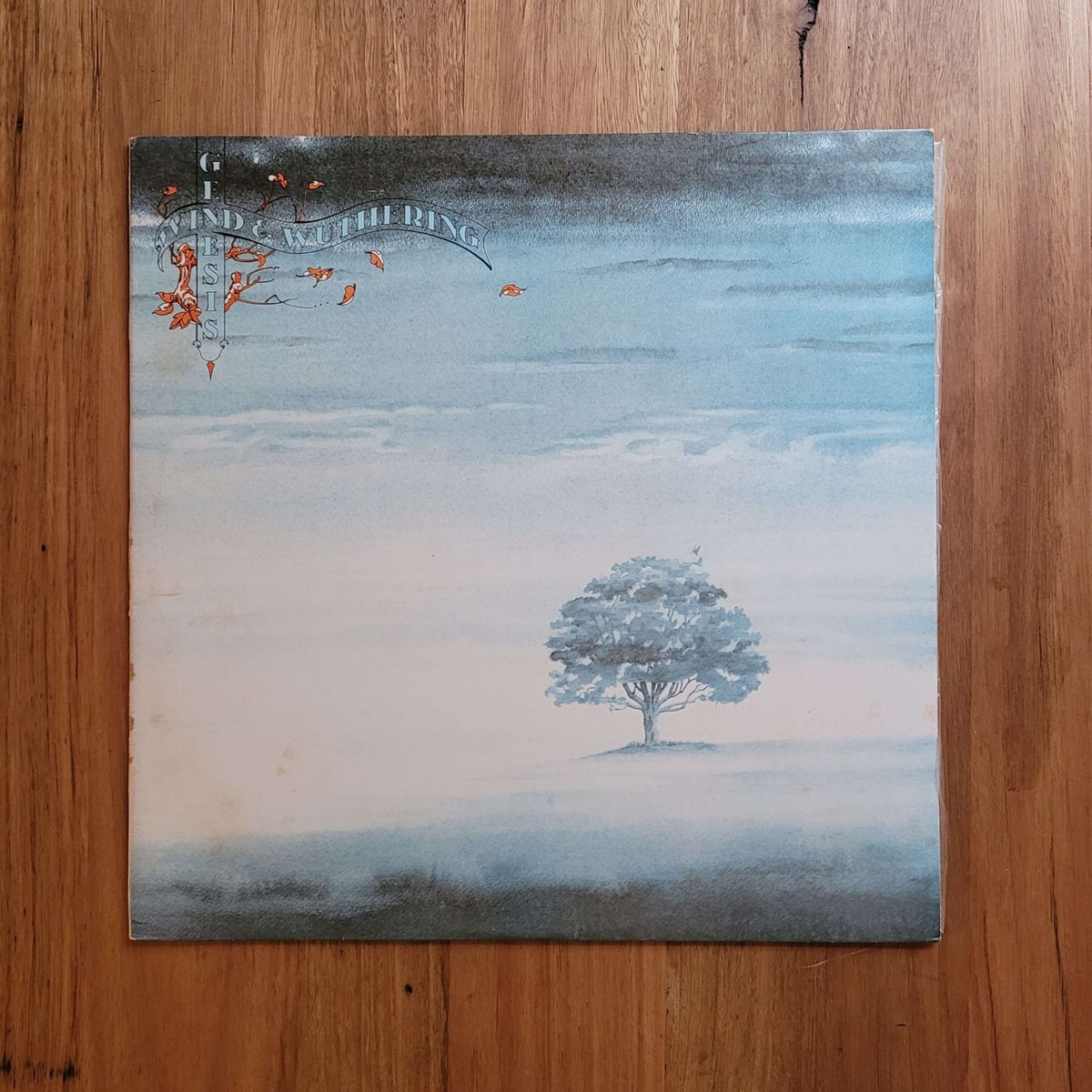 Album cover of Wind & Wuthering by Genesis featuring a serene tree against a misty blue background.