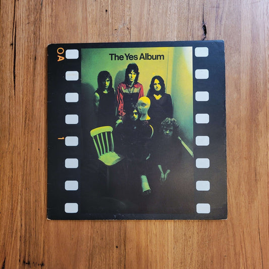 Cover art of The Yes Album by Yes, showcasing band members in a vintage film strip design.